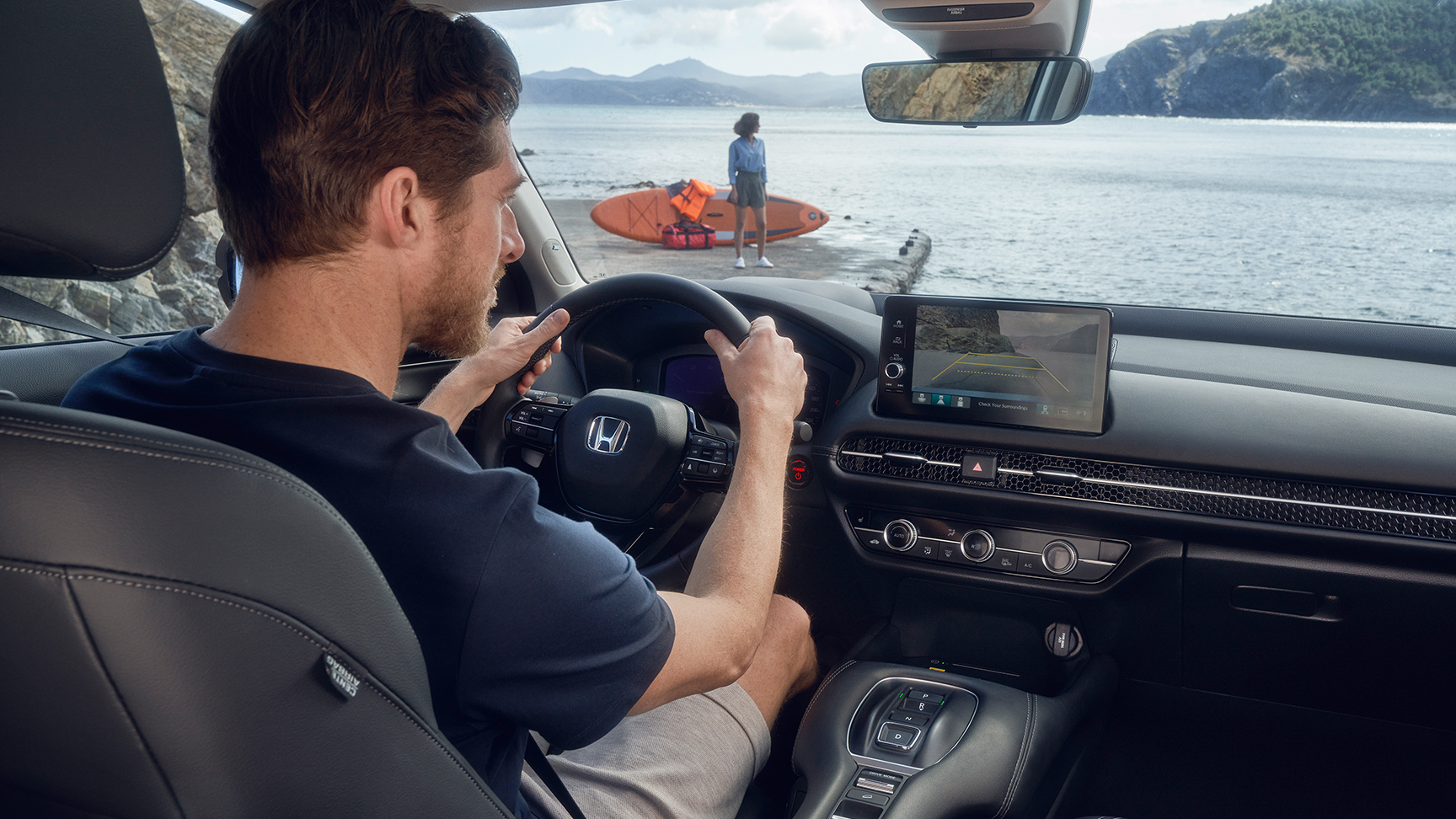 Muž za volantom vozidla ZR-V so zobrazenými parkovacími asistentmi