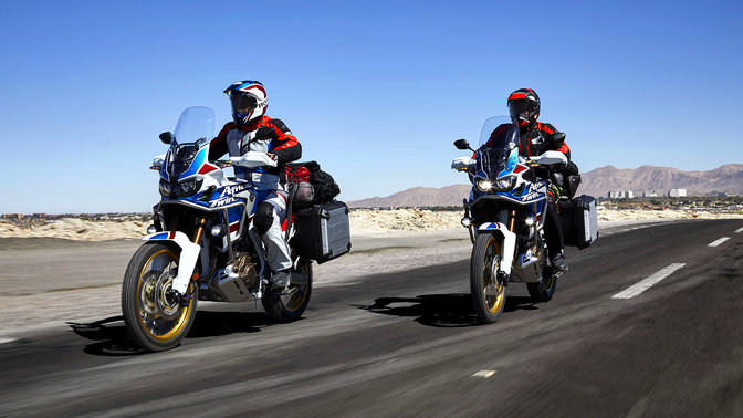Dvaja jazdci na motocykloch Honda Africa Twin Adventure Sports na ceste.