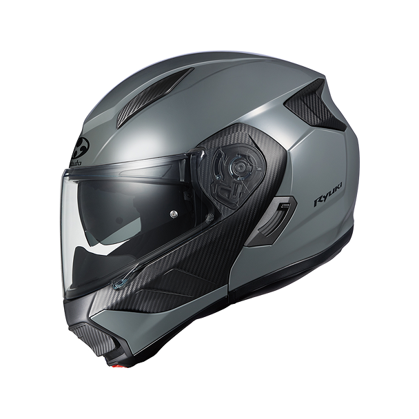 A sleek, modern motorcycle helmet in metallic gray with carbon fiber accents. The helmet features a flip-up chin bar and visor, typical of a modular design. The model appears to be an OGK Ryuki, showcasing a blend of safety and style for motorcycle riders.