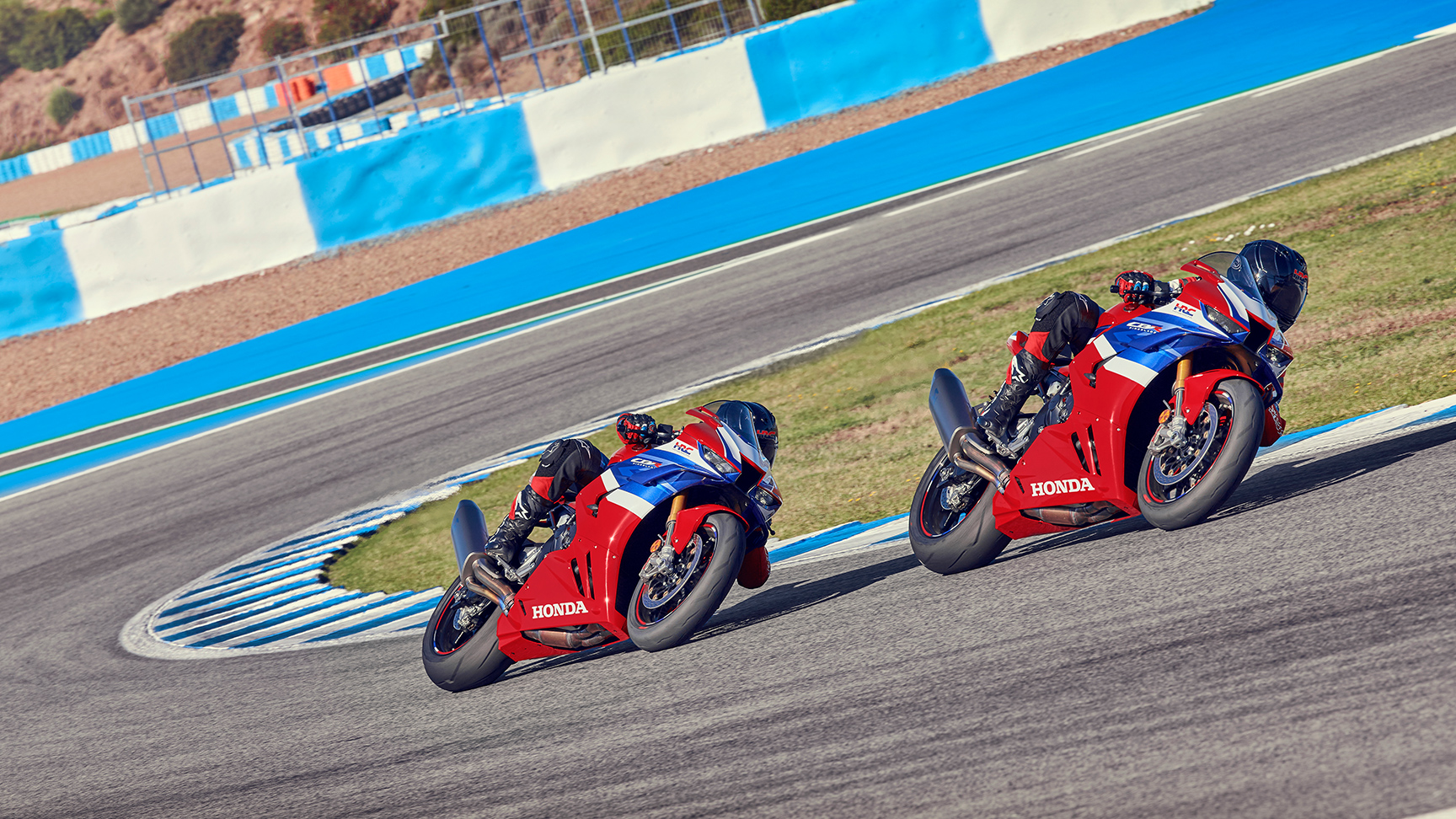 Dvaja jazdci s Hondami CBR1000rr-r Fireblade na trati v strede zákruty